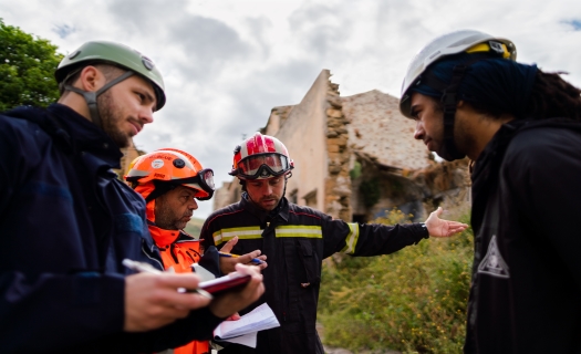 Structural engineers in disaster relief training in earthquake ruins.