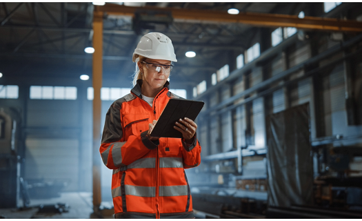 woman in manufacturing job using tablet