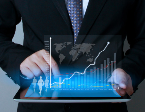 Man holding virtual graphic display springing from his laptop