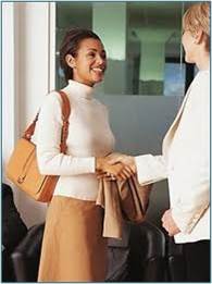 standing woman shaking hands with standing man