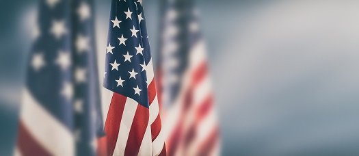 American flags on blurred outdoor background