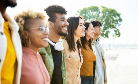 Photo of six young people in profile, smiling