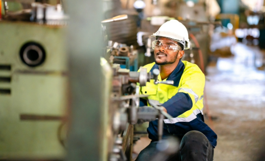 A young man working in manufacturing.