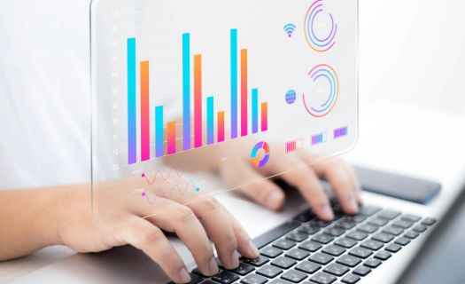 Hands typing on a keyboard with an image of a bar graph overlayed.