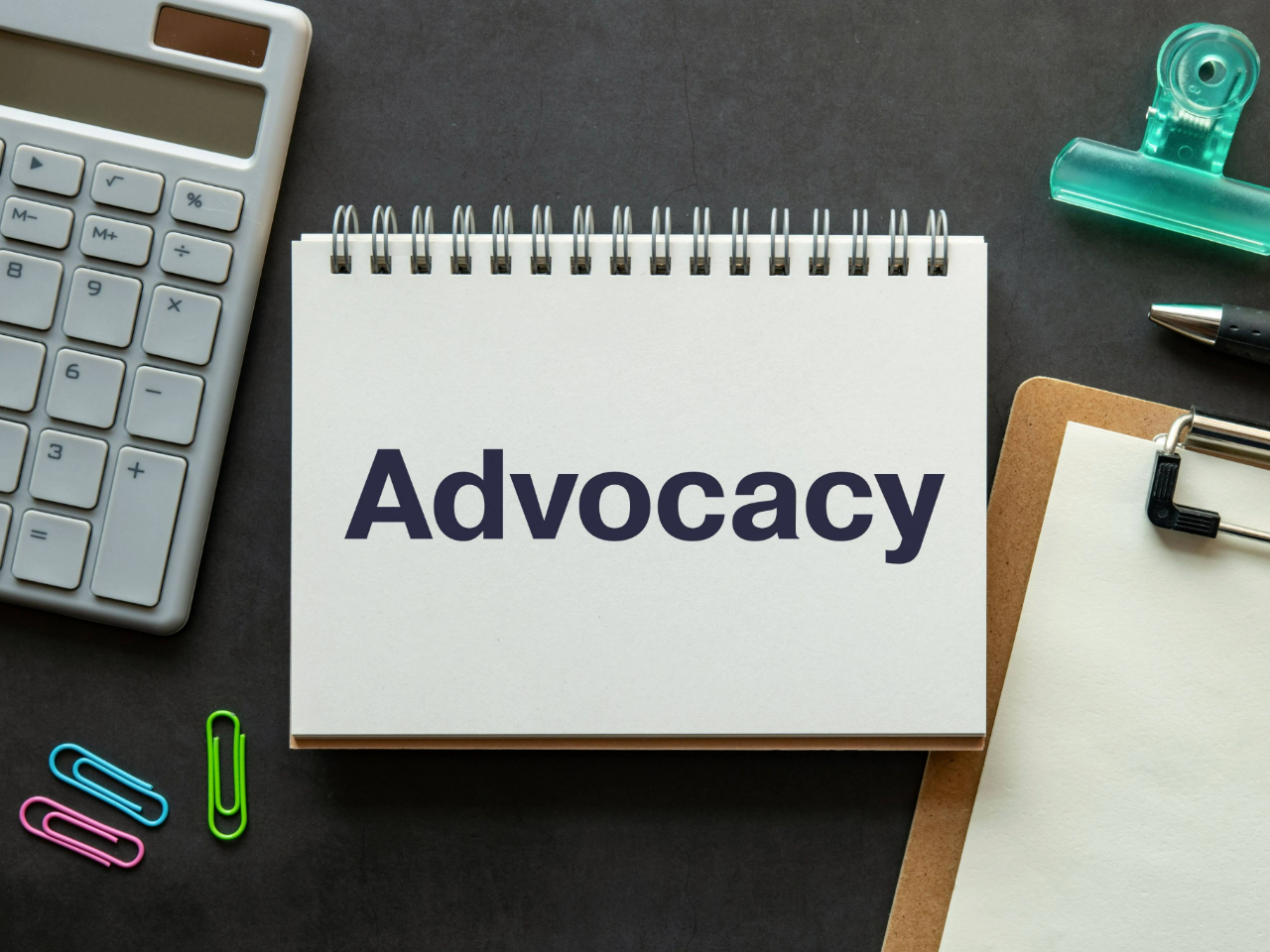 Advocacy printed on a spiral notebook on a desk.