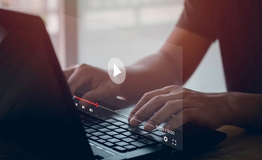 Person navigating  a video on a laptop