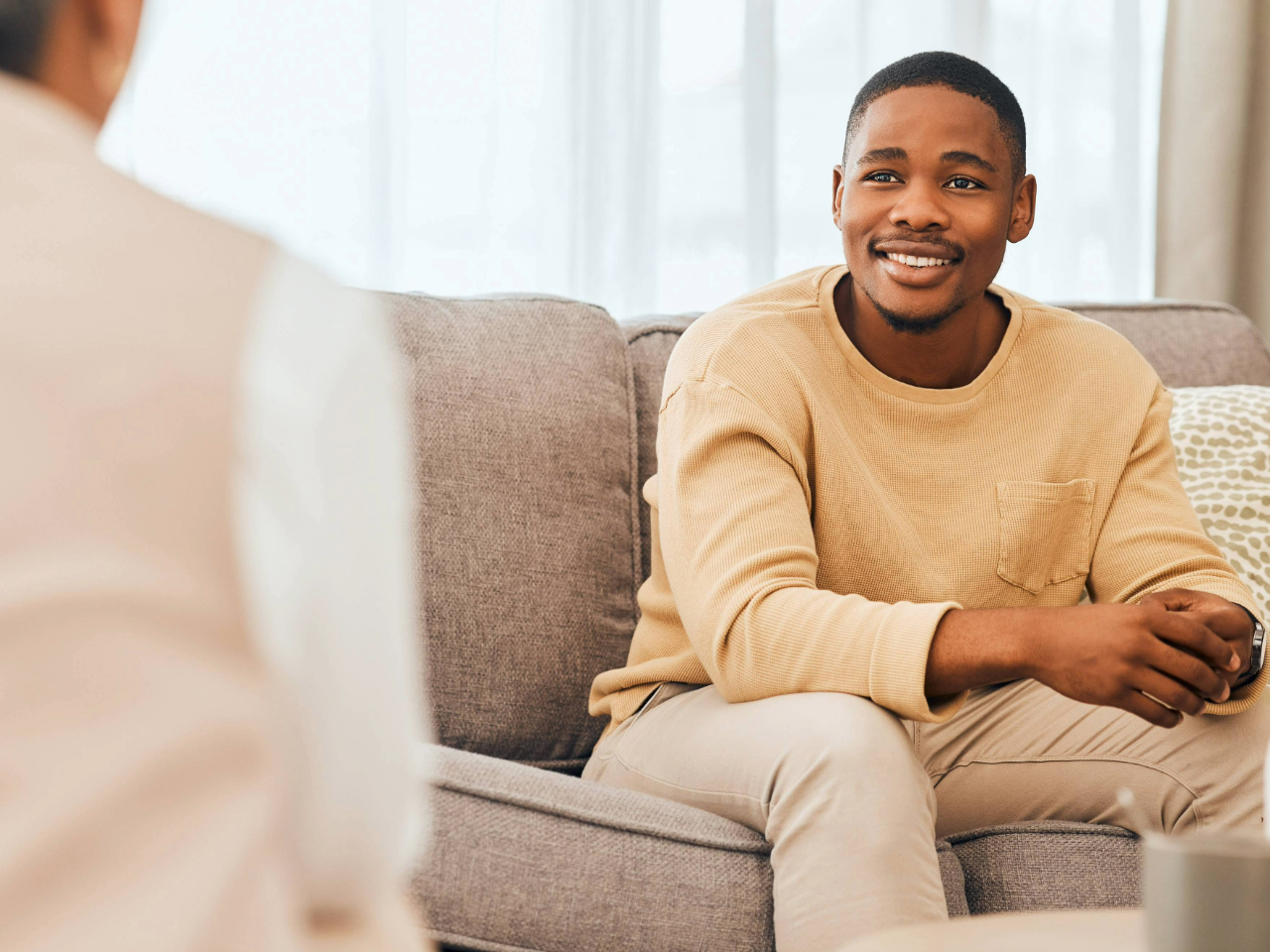 Man sitting on couch at counselor's office